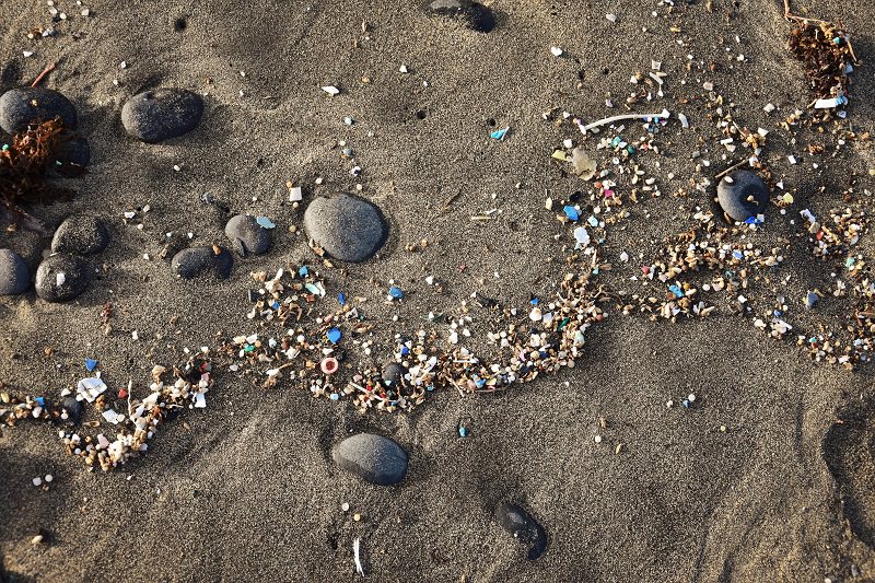 nurdles and other microplastics littering shoreline on a beach