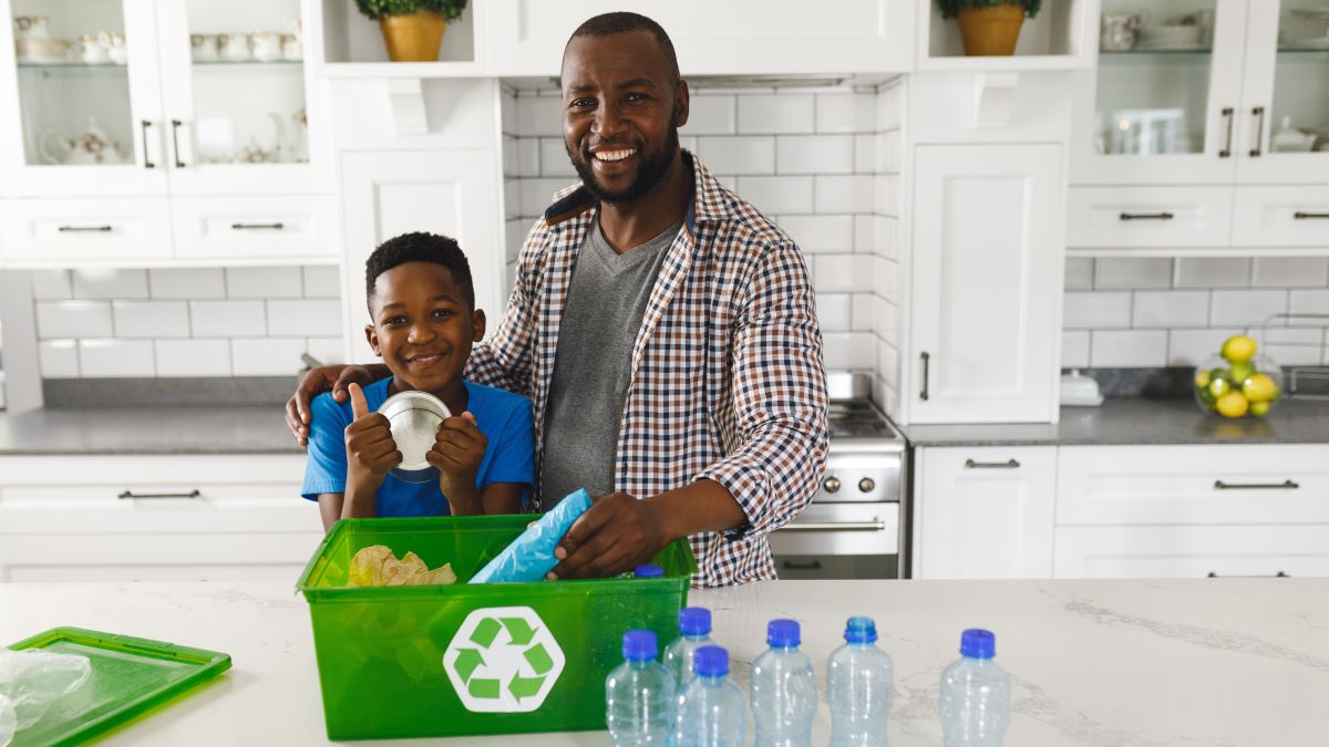 Father and son sorting recycling at home