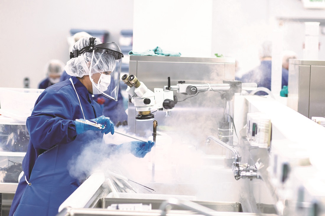 Workers clean and sterilize medical devices for hospital reuse