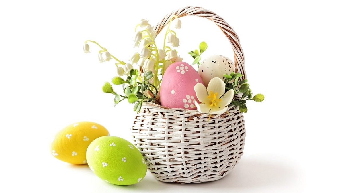 Easter eggs and flowers in basket