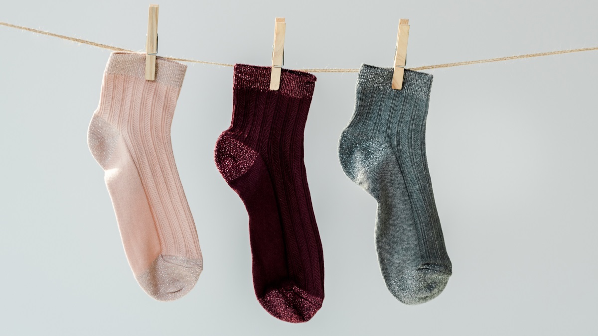 Three single socks hanging on line