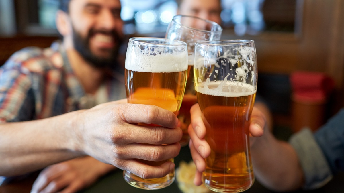 Men drinking beer together, making a toast