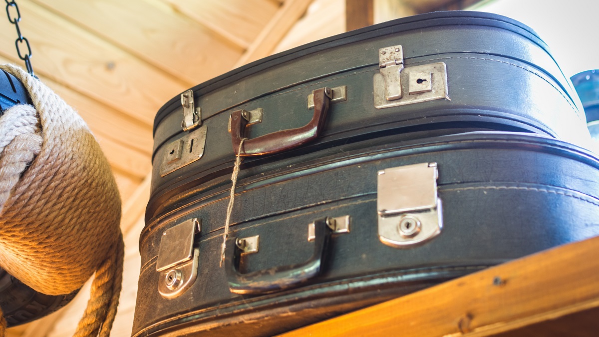 old suitcases stored on a closet shelf
