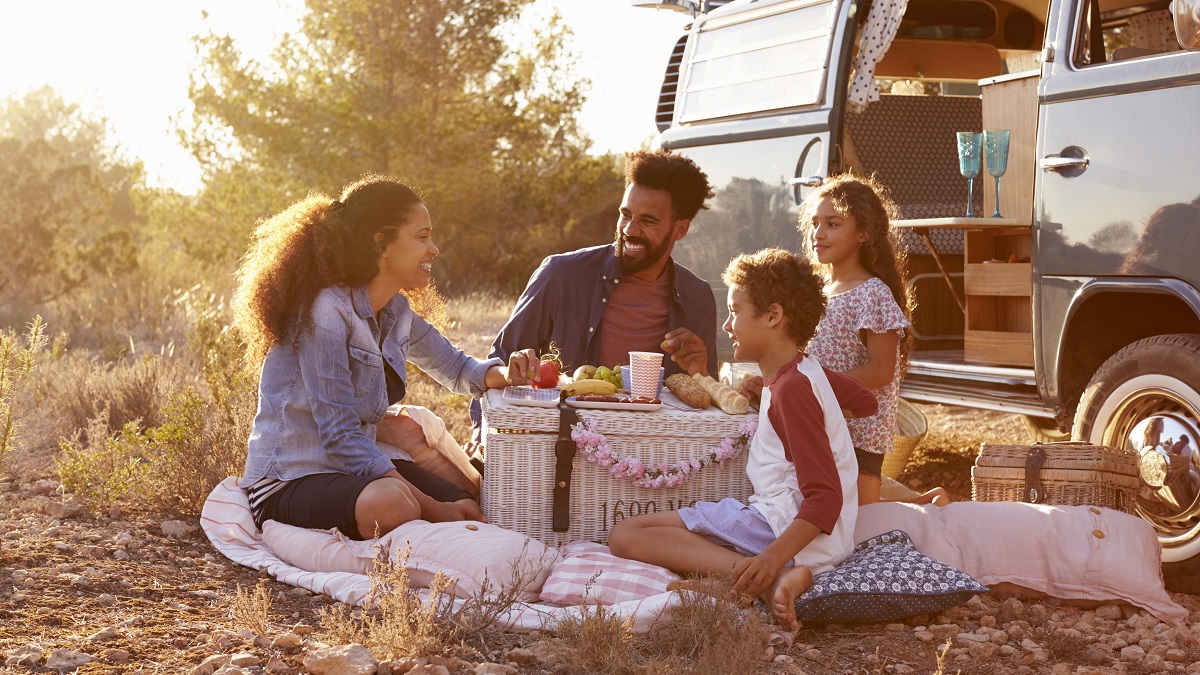 Family having picnic beside their camper van