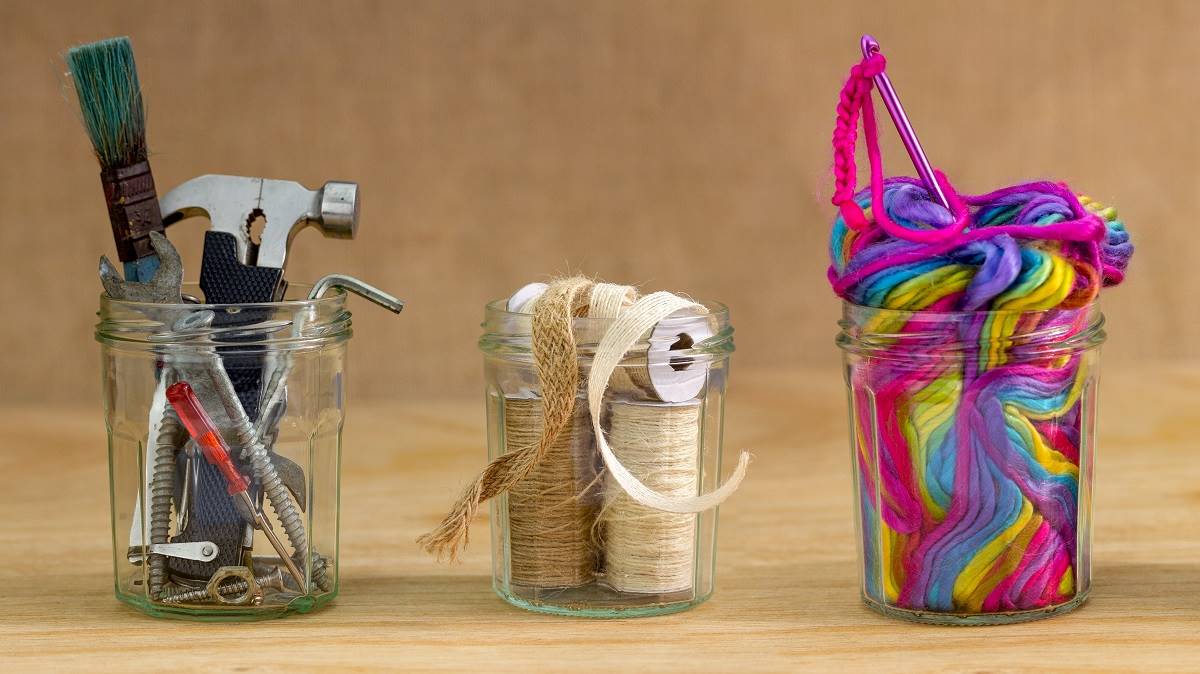 Reused jars holding tools and crafting materials
