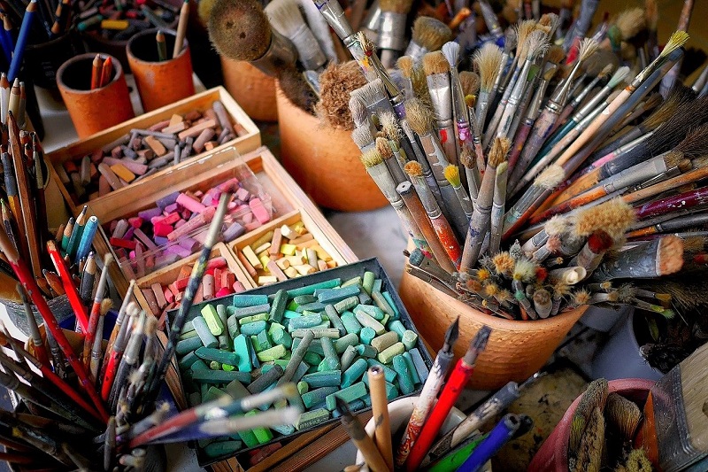 used brushes, pastels and other art supplies