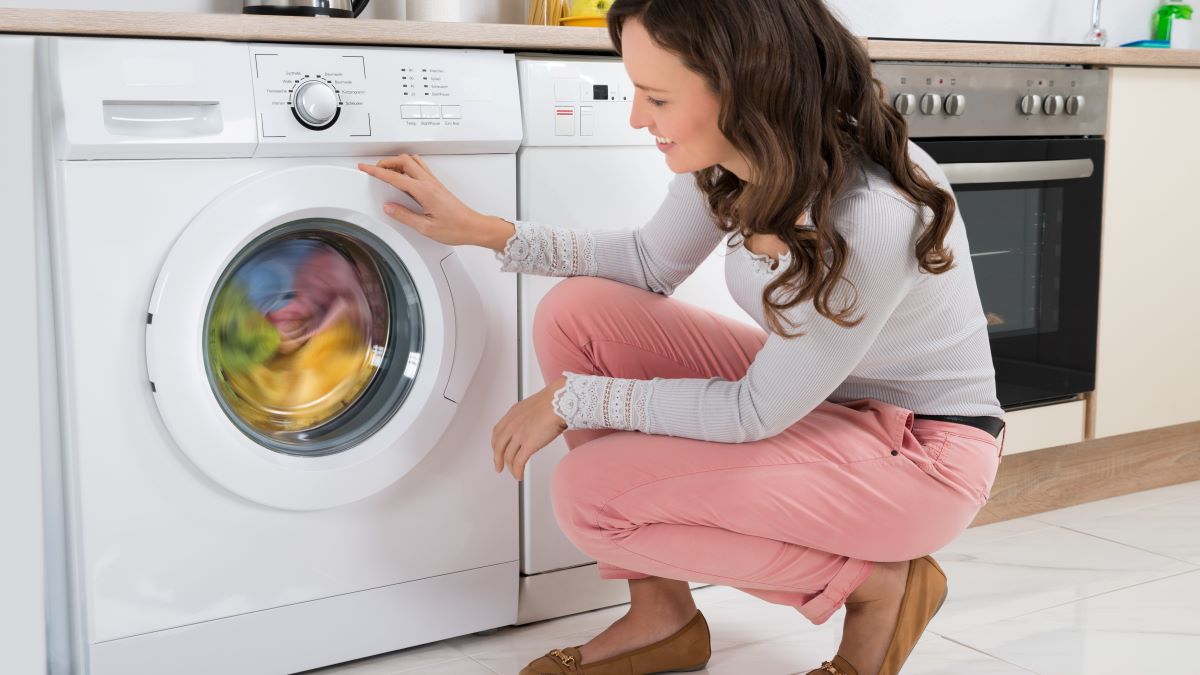 Woman watching her front-load washer run
