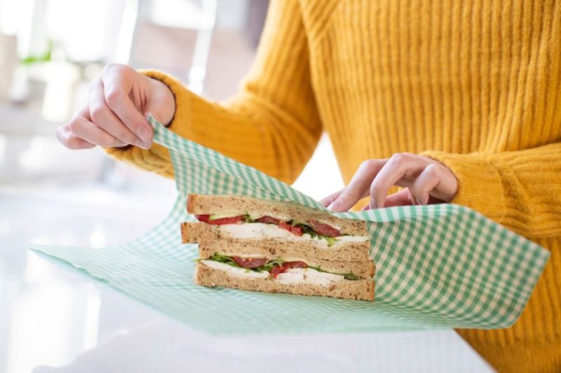 woman wrapping sandwich in reusable waxed cloth