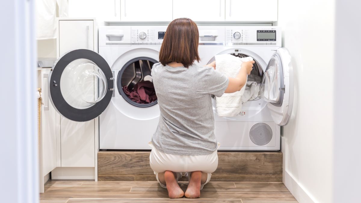 Woman removing items from clothes dryer