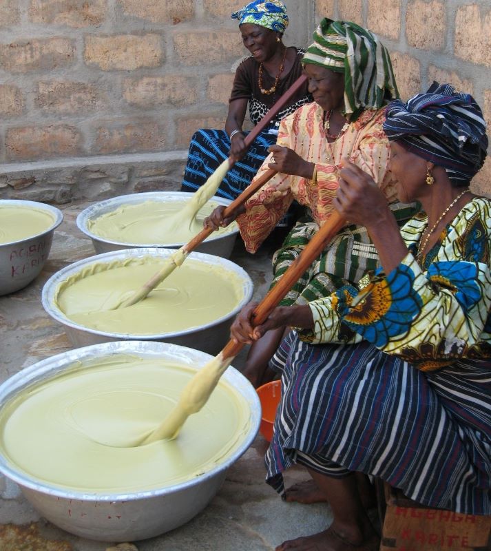 Alaffia workers hand-stirring shea butter