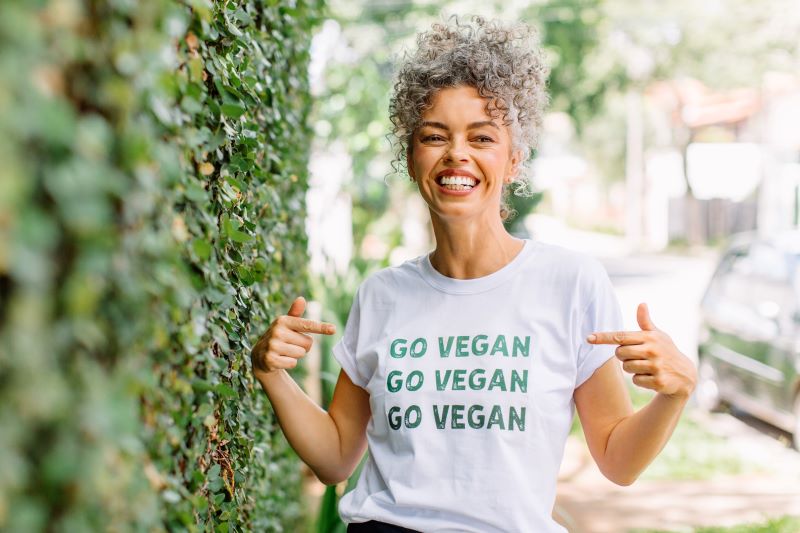 Smiling woman wearing "Go vegan" shirt