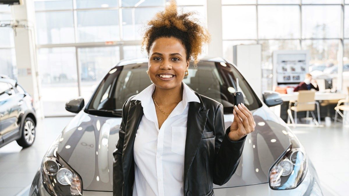 Woman with keys to brand new car