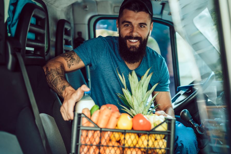 Young man in food delivery van