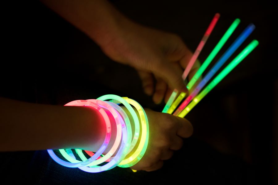 Close up of hands holding glow sticks