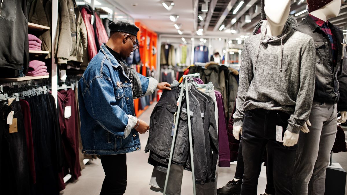 Man looking at jacket in clothing store