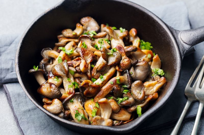 Sauteed mushrooms with herbs in cast-iron skillet