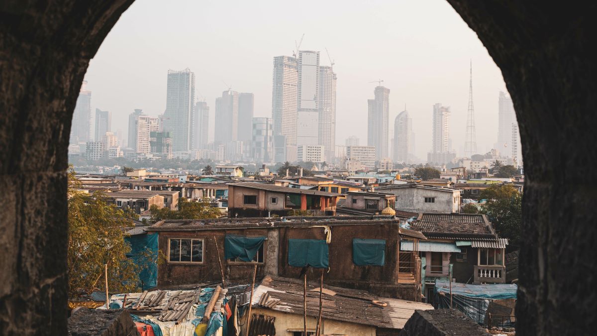 Mumbai, India, ghetto in foreground with high-rise buildings in distance,