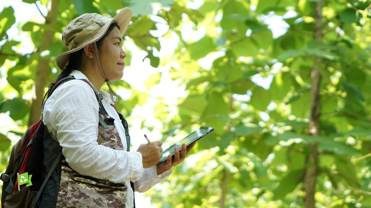 Woman with tablet PC in forest
